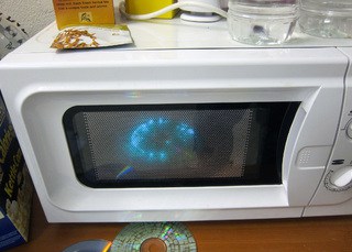 microwave on top of refrigerator